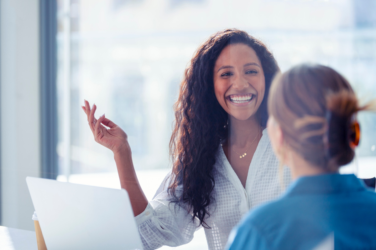 Benecard Woman Smiling at Colleague