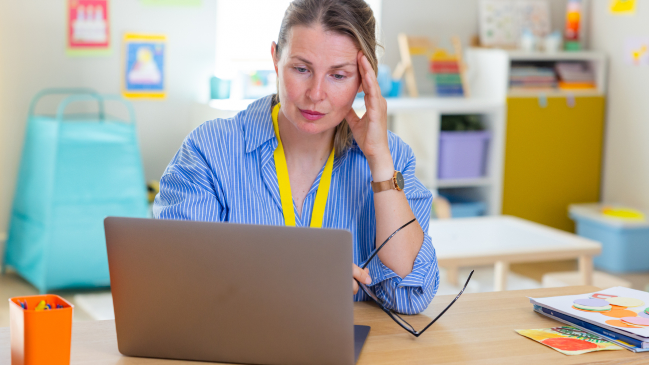 Teachers looking stressed while reviewing the computer screen