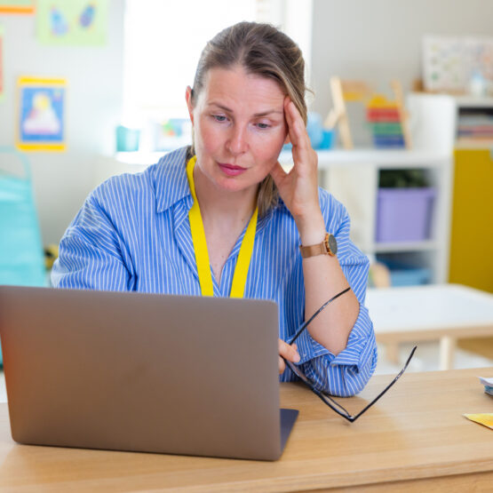 Teachers looking stressed while reviewing the computer screen